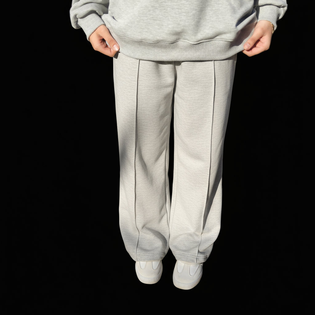 Person wearing a gray hoodie and  sweatpants