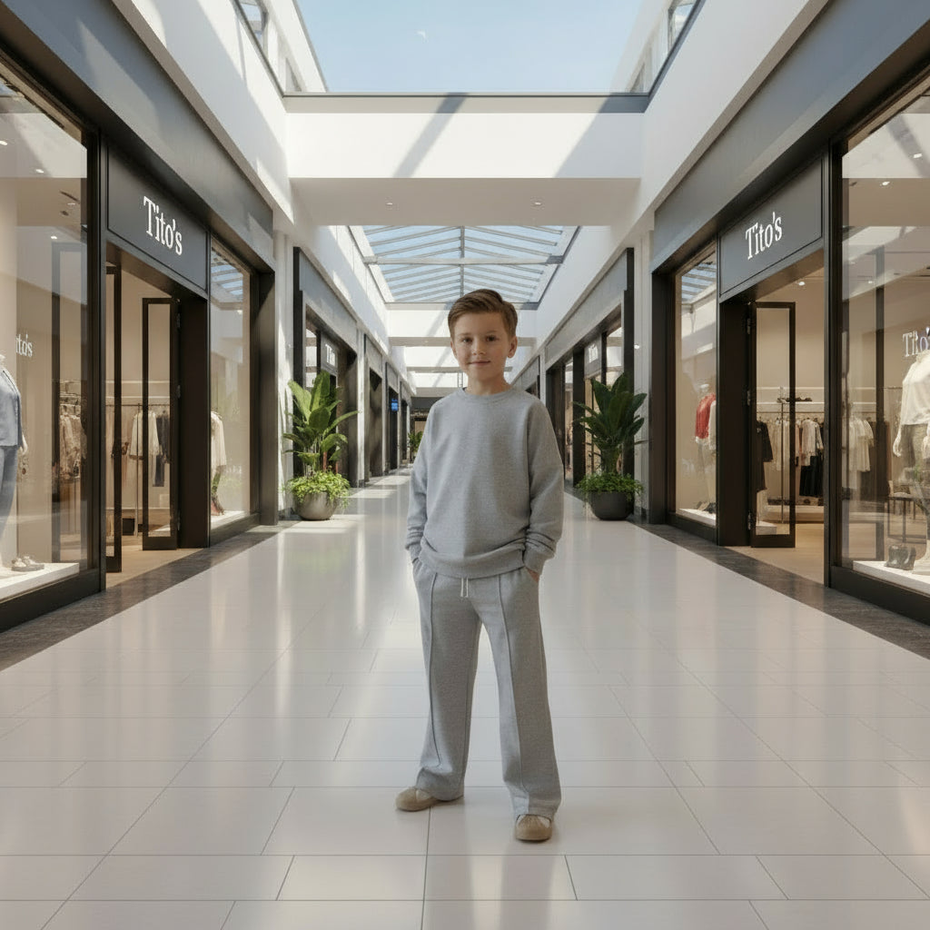 Young boy standing in a modern, open air mall.