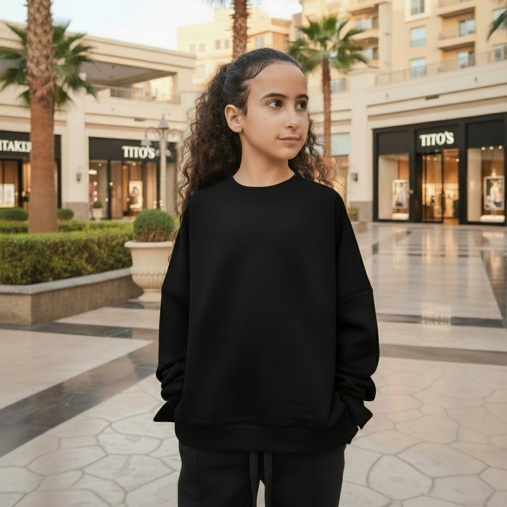 Person wearing a black outfit standing in open air mall