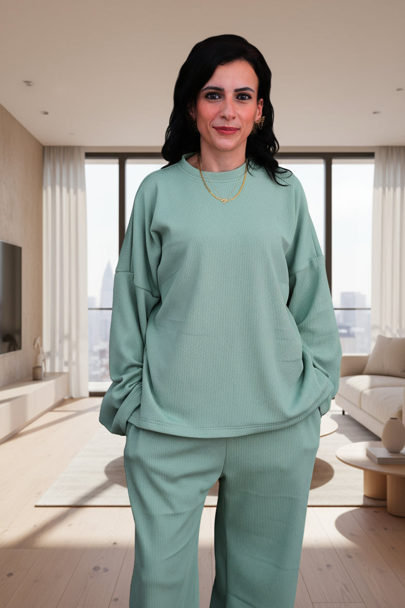 Woman wearing a green outfit on a black background
