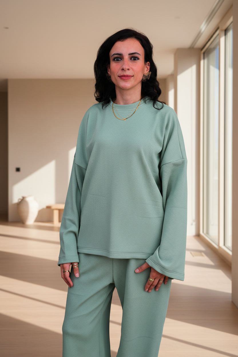 Woman wearing a green outfit on a black background
