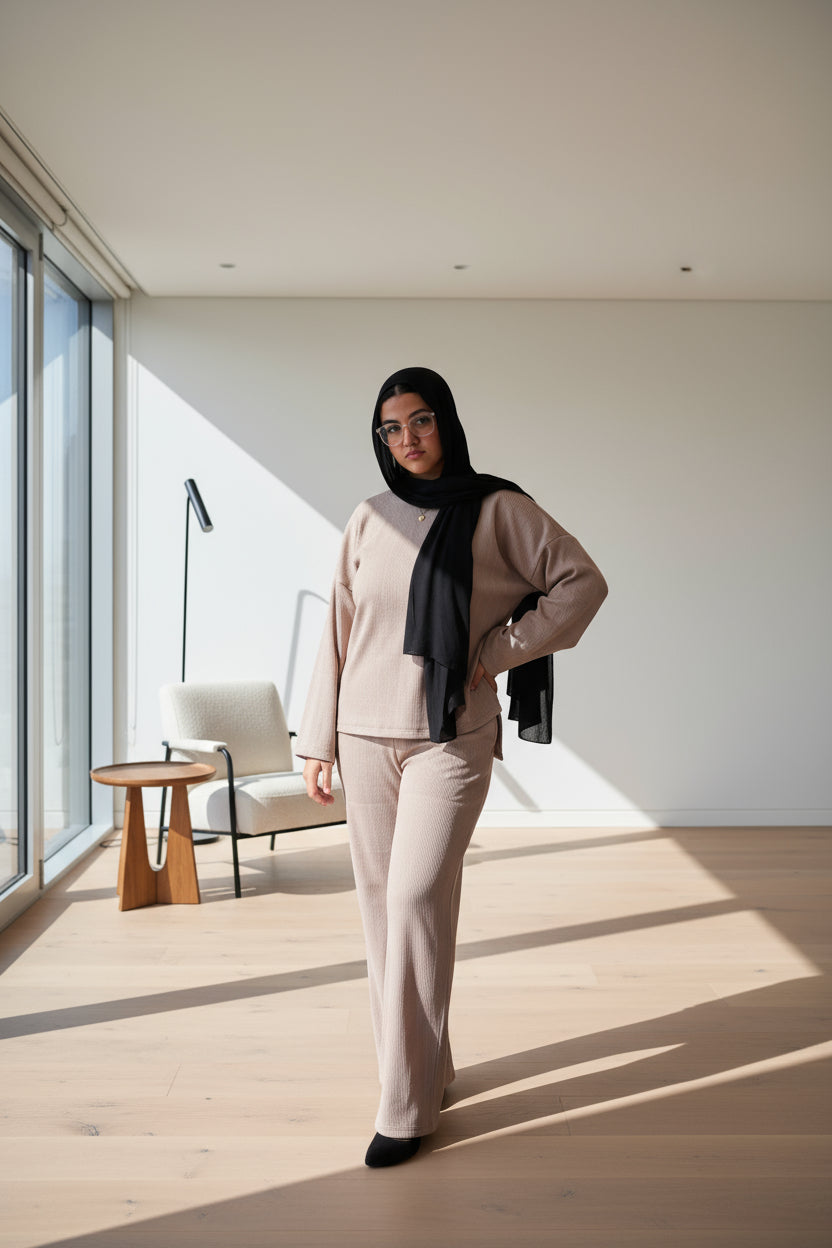 Woman wearing a cafe outfit with a black hijab on a black background