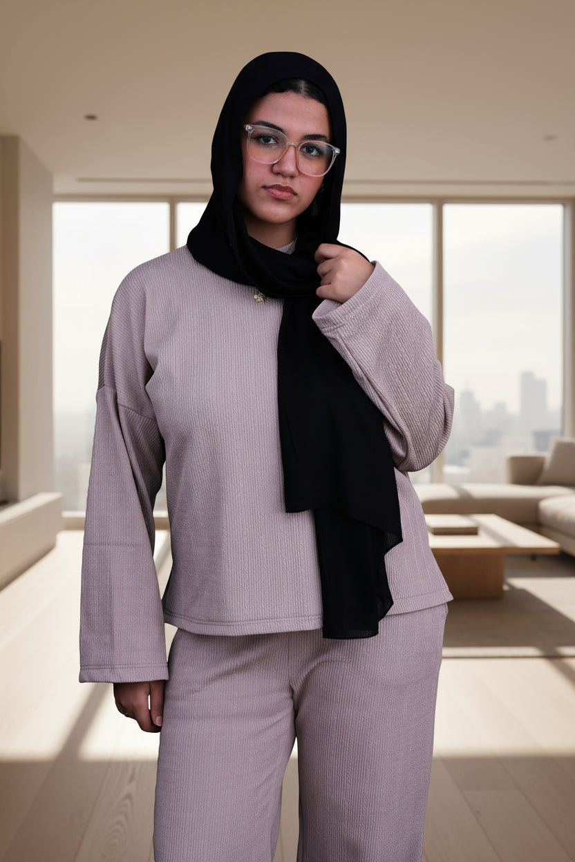 Woman wearing a cafe outfit with a black hijab on a black background