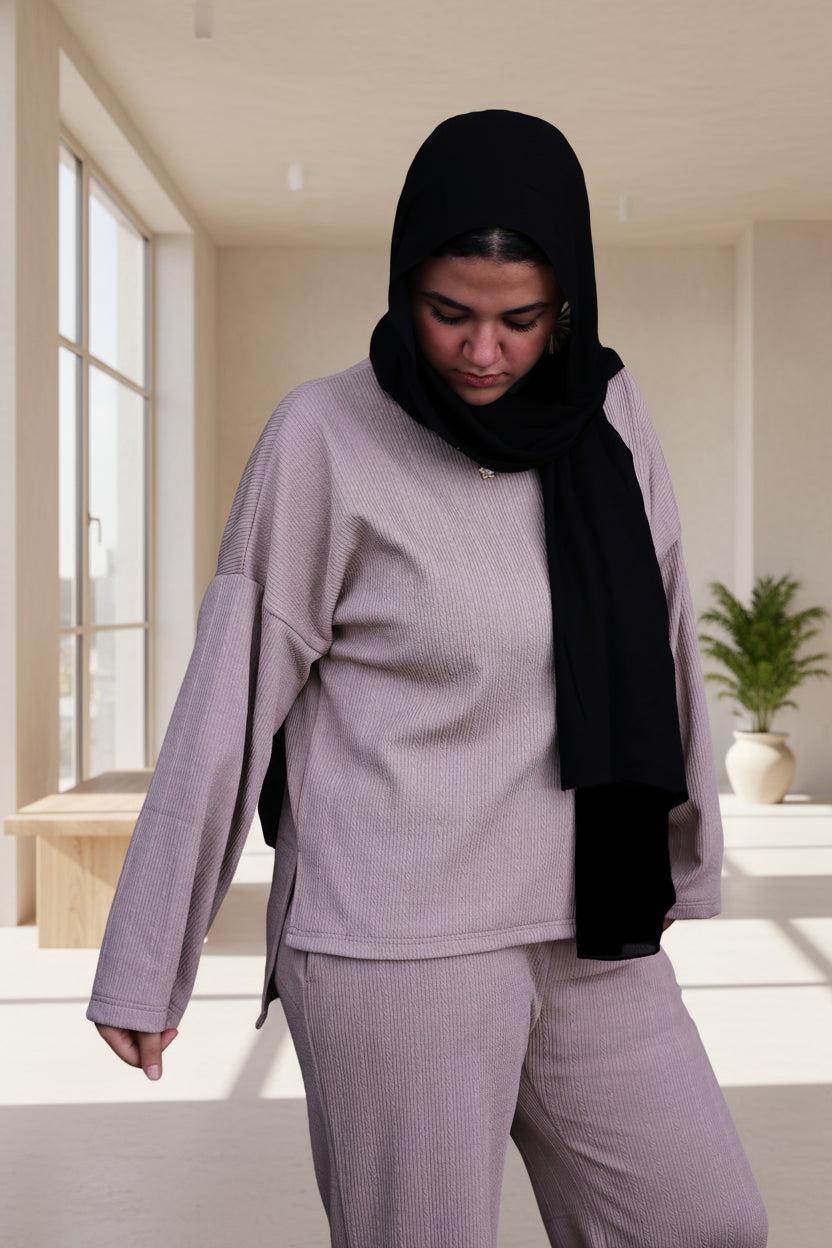 Woman wearing a cafe outfit with a black hijab on a black background
