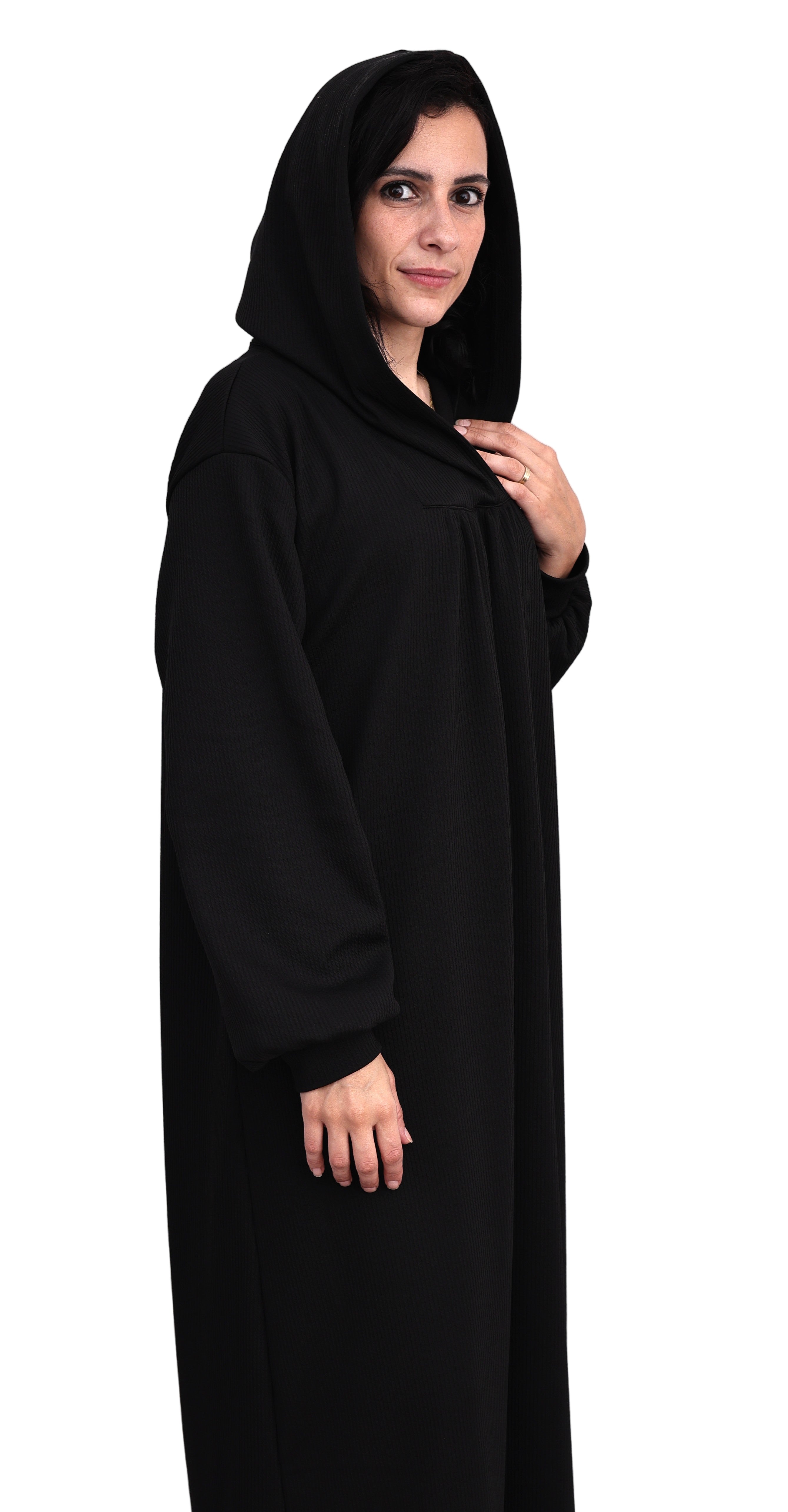 Person wearing a black abaya against a white background